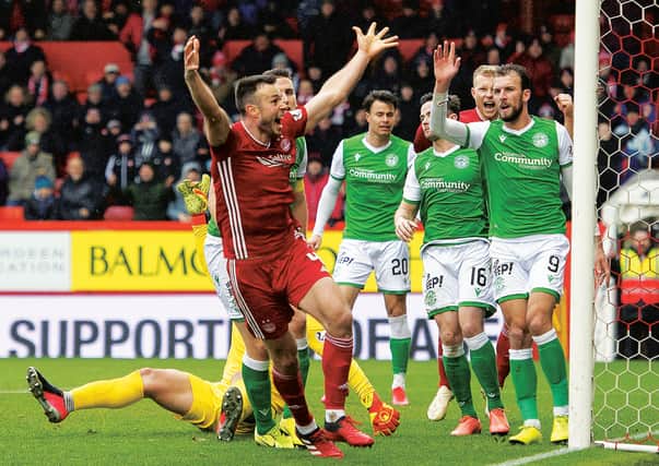 Andrew Considine celebrates putting Aberdeen ahead against Hibernian. Picture: Paul Devlin / SNS