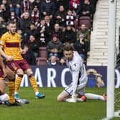 Conor Washington, grounded, slides in to score Hearts’ equaliser against Motherwell. Picture: SNS