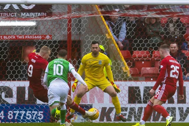 Curtis Main slots home Aberdeen’s third goal against Hibernian at Pittodrie on Saturday. Picture: SNS