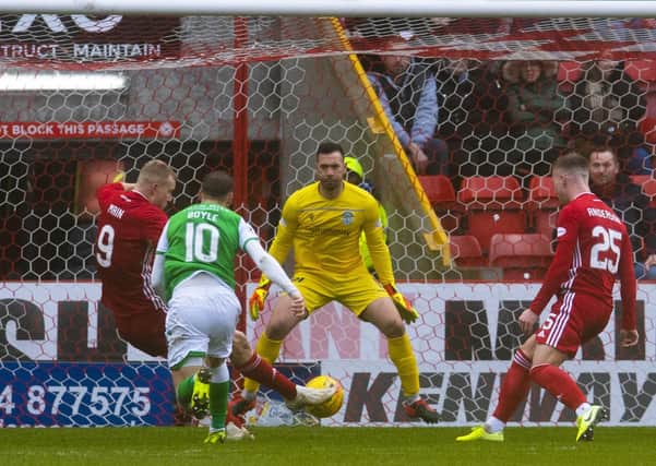 Curtis Main slots home Aberdeen’s third goal against Hibernian at Pittodrie on Saturday. Picture: SNS