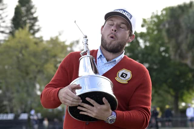 Englishman Tyrrell Hatton shows what winning the Arnold Palmer Invitational means to him after getting his hands on the trophy. Picture: AP.