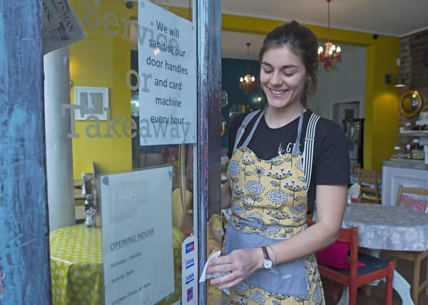 Staff at Piecebox cafe in Polworth putting out anti-bacterial wipes and regularly cleaning the door handles (Picture: Neil Hanna)