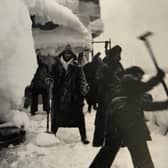 Merchant Navy crews who left Loch Ewe in the Highlands smash ice off their vessel as it heads up through the Arctic Circle to Russia during World War Two. PIC: Contributed.