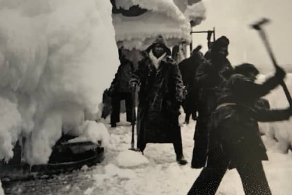 Merchant Navy crews who left Loch Ewe in the Highlands smash ice off their vessel as it heads up through the Arctic Circle to Russia during World War Two. PIC: Contributed.