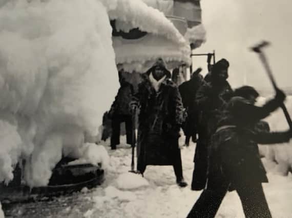 Merchant Navy crews who left Loch Ewe in the Highlands smash ice off their vessel as it heads up through the Arctic Circle to Russia during World War Two. PIC: Contributed.