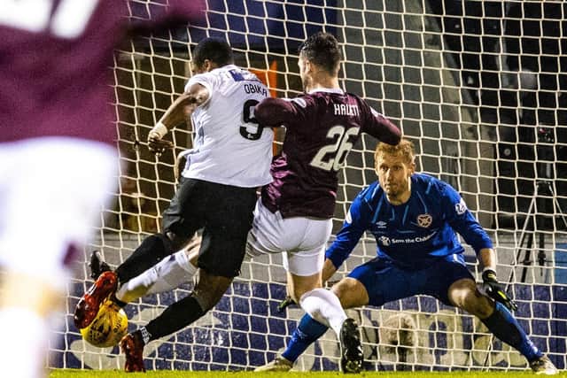 St Mirren's Jon Obika scores despite the challenge from Hearts' Craig Halkett. Picture: Paul Devlin / SNS