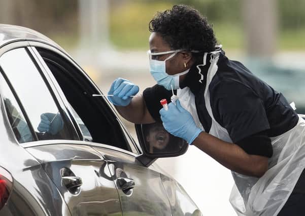 A nurse takes a swab at a Covid-19 drive-through testing station for NHS staff (Picture: Dan Kitwood/Getty Images)