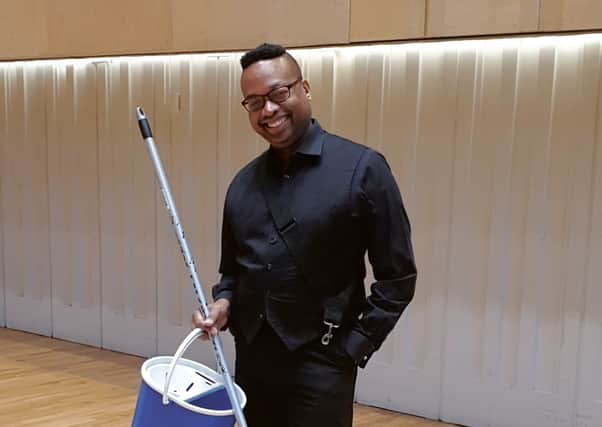 Paul Philbert, the RSNO's principal timpanist, poses with a mop and bucket to promote RSNO Challenges