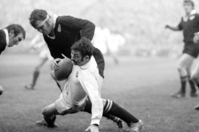 Ian McCrae, with the ball, is tackled by New Zealand’s Kent Lambert at Murrayfield in 1972. Picture: PA