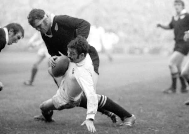 Ian McCrae, with the ball, is tackled by New Zealand’s Kent Lambert at Murrayfield in 1972. Picture: PA