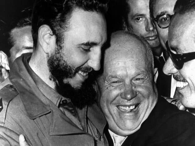 Cuban president Fidel Castro, left, and Soviet leader Nikita Khrushchev hug at the United Nations in this late 1960 file photo. (Picture: Marty Lederhandler/AP)