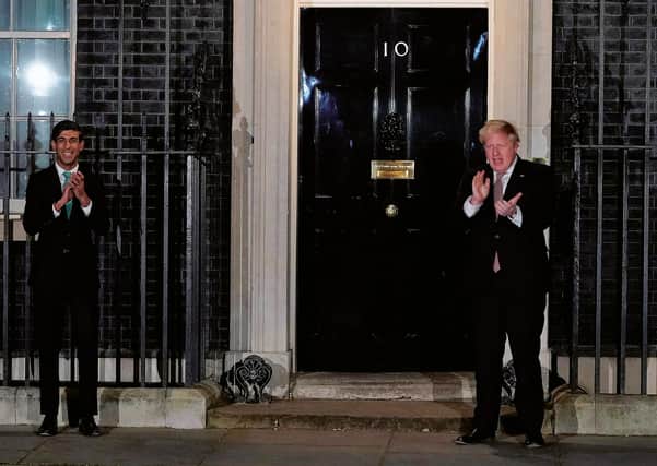 Rishi Sunak and Boris Johnson put their hands together for the National Health Service.
Photograph:
Andrew Parsons/Getty