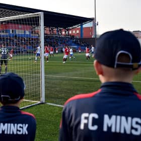 FC Minsk supporters watch their team win a thriller in their local derby match against Dinamo.