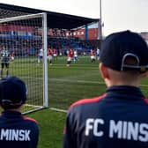 FC Minsk supporters watch their team win a thriller in their local derby match against Dinamo.