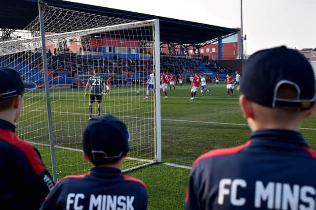 FC Minsk supporters watch their team win a thriller in their local derby match against Dinamo.