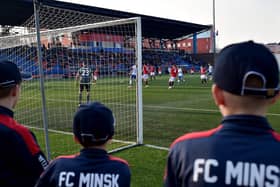 FC Minsk supporters watch their team win a thriller in their local derby match against Dinamo.