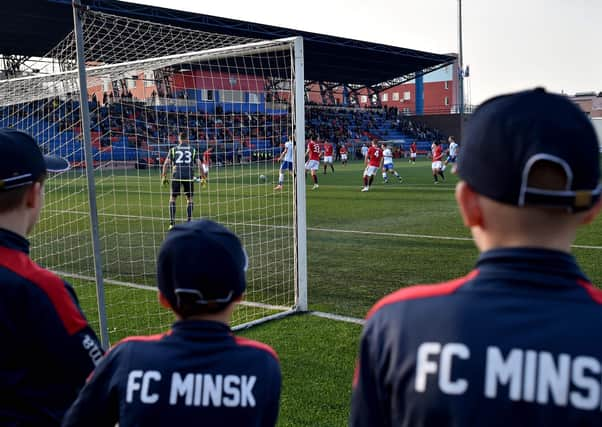 FC Minsk supporters watch their team win a thriller in their local derby match against Dinamo.