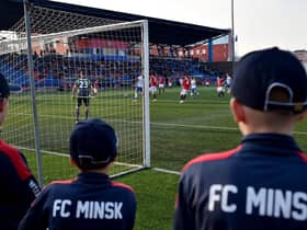 FC Minsk supporters watch their team win a thriller in their local derby match against Dinamo.