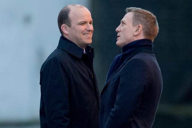 Rory Kinnear (left) chats with Daniel Craig as they film a scene on a London canal for the James Bond movie Spectre. Picture: Matt Dunham/AP/Shutterstock