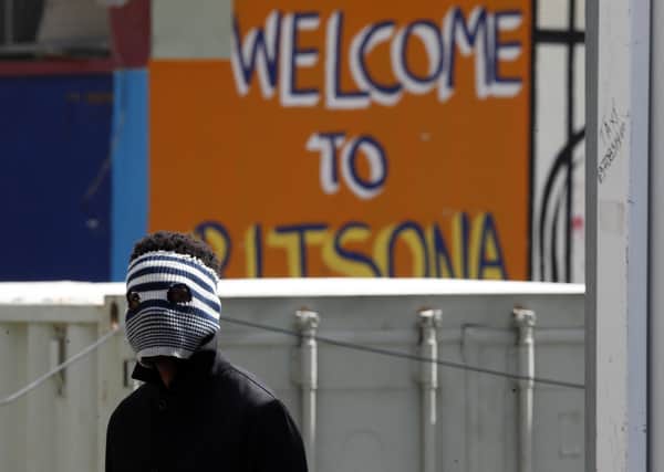 A young migrant wears an improvised mask at Ritsona refugee camp north of Athens as fear grows over the coronavirus pandemic (Picture: Thanassis Stavrakis/AP)