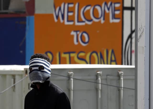 A young migrant wears an improvised mask at Ritsona refugee camp north of Athens as fear grows over the coronavirus pandemic (Picture: Thanassis Stavrakis/AP)