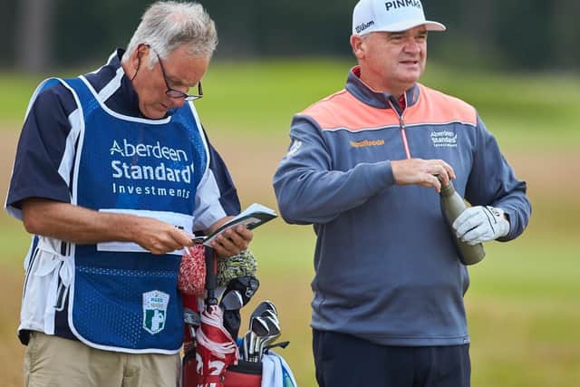 Paul Lawrie, pictured talking over yardage with his caddie Julian Phillips during last year's Aberdeen Standard Investments Scottish Open at The Renaissance Club, believes there are more important things than sport in life at the moment. Picture: Aberdeen Standard Investments