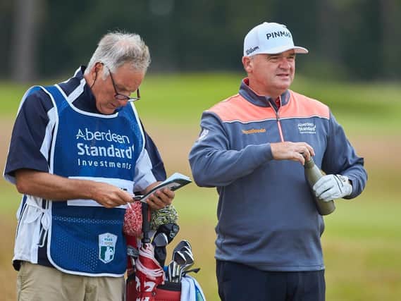 Paul Lawrie, pictured talking over yardage with his caddie Julian Phillips during last year's Aberdeen Standard Investments Scottish Open at The Renaissance Club, believes there are more important things than sport in life at the moment. Picture: Aberdeen Standard Investments