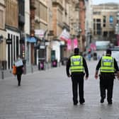 Police patrol an empty Buchanan Street. Picture: John Devlin