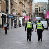 Police walk an empty Buchanan Street in Glasgow as lockdown restrictions take force. Picture: John Devlin