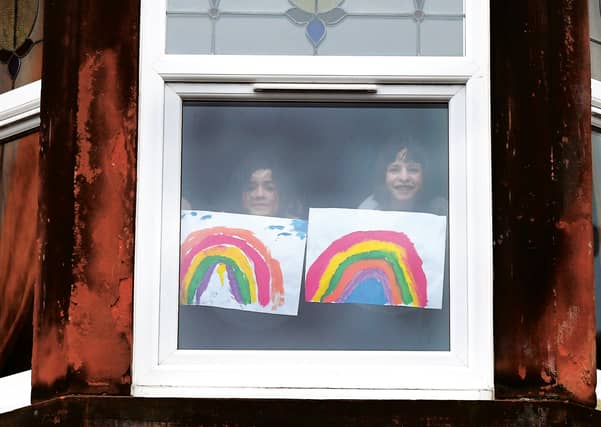 Children in Glasgow put paintings of rainbows in the window to raise the spirits of passers-by. Picture:
John Devlin