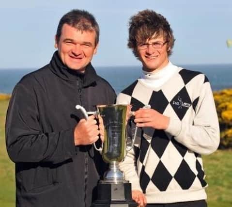 2009 Scottish Boys' champion David Law holds the trophy with Paul Lawrie.