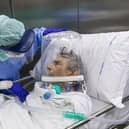 A nurse attends to a Covid-19 patient being moved out of intensive care in a hospital in Bergamo, Italy (Picture: Marco di Lauro/Getty Images)