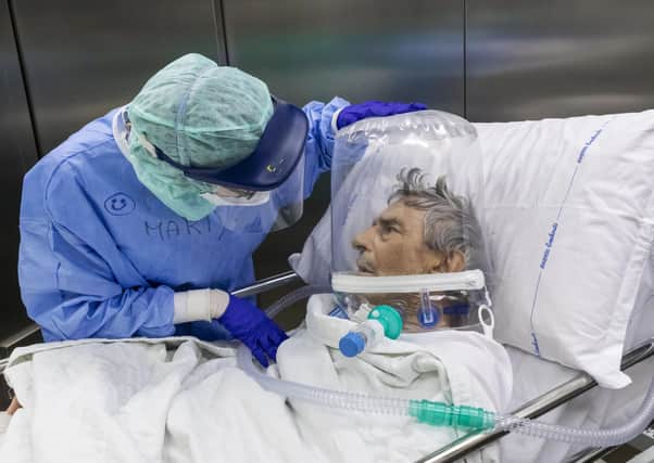 A nurse attends to a Covid-19 patient being moved out of intensive care in a hospital in Bergamo, Italy (Picture: Marco di Lauro/Getty Images)
