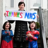 A family joins in the applause for the NHS in Glasgow (Picture: John Devlin)