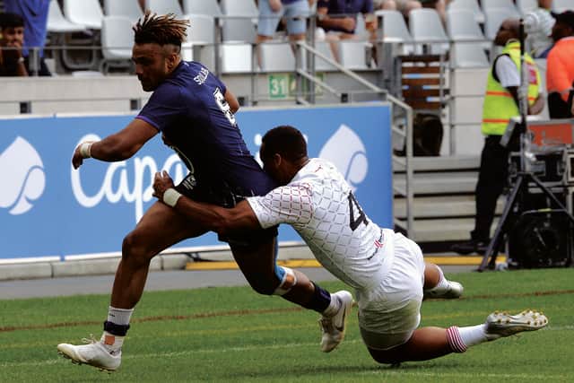 Scotland's Femi Sofolarin runs past England's Dan Norton to score a try during the World Rugby Sevens Series in Cape Town in December. Picture: Rodger Bosch/Getty