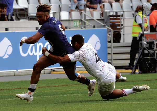 Scotland's Femi Sofolarin runs past England's Dan Norton to score a try during the World Rugby Sevens Series in Cape Town in December. Picture: Rodger Bosch/Getty
