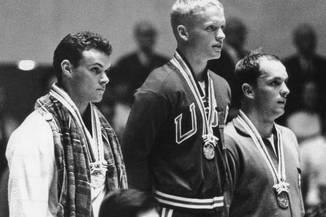 Bobby McGregor, left, is 'scunnered' as he collects his silver medal after the 100m freestyle race at the Tokyo Olympics in 1964. Picture: Keystone/Getty Images