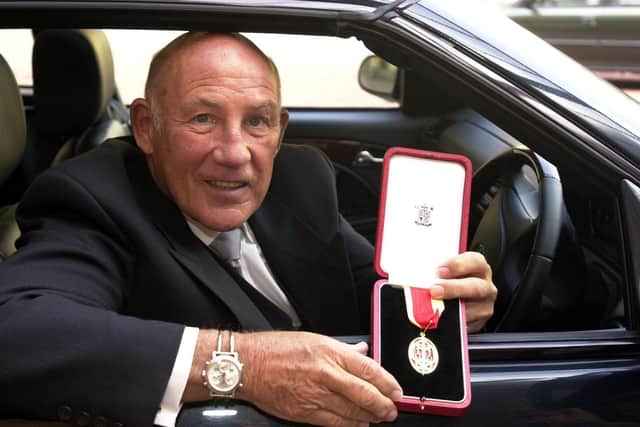 Sir Stirling Moss gets back behind the wheel after receiving his knightood in 1999 (Picture: John Stillwell/PA Wire)