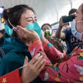 A medical staff member from Peking Union Medical College Hospital, left, tears up as she prepares to leave Wuhan, but was China's government slow to act over the virus? (Picture: STR/AFP via Getty Images)