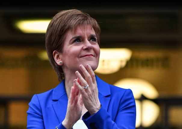 Nicola Sturgeon, seen applauding NHS staff, warned Scotland would face a 'new normal' when it becomes possible to start relaxing current lockdown restrictions (Picture: Jeff J Mitchell/Getty Images)