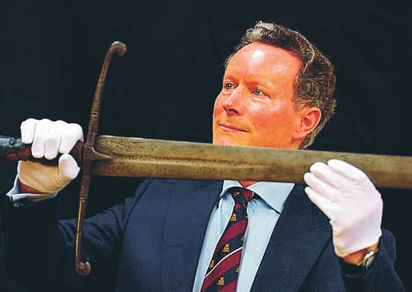 Lord Charles Bruce holds his ancestor's state sword