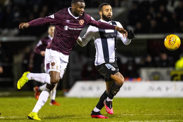 Clevid Dikamona, battling with St Mirren’s Alex Jakubiak, finds it difficult to explain why Hearts have plumbed the depths in the Premiership. Picture: SNS.