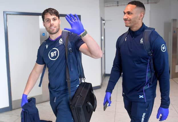 Wingers Sean Maitland, left, and Ratu Tagive wearing gloves at Edinburgh Airport as Scotland checked in for their flight to Cardiff amid concerns over the coronavirus outbreak. Picture: Gary Hutchison/SNS