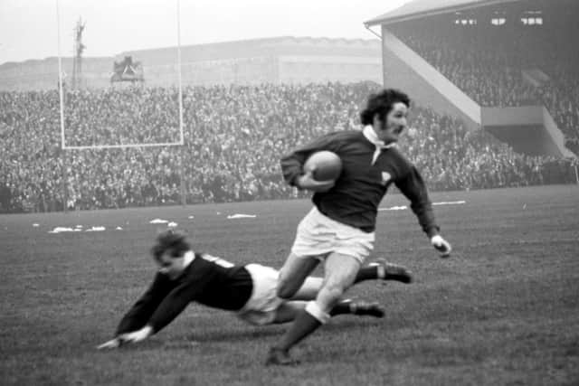 Gerald Davies jinks past Ian Smith to score a try in his country’s thrilling 19-18 win over Scotland at Murrayfield in February 1971