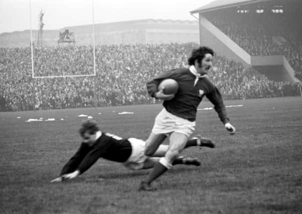 Gerald Davies jinks past Ian Smith to score a try in his country’s thrilling 19-18 win over Scotland at Murrayfield in February 1971