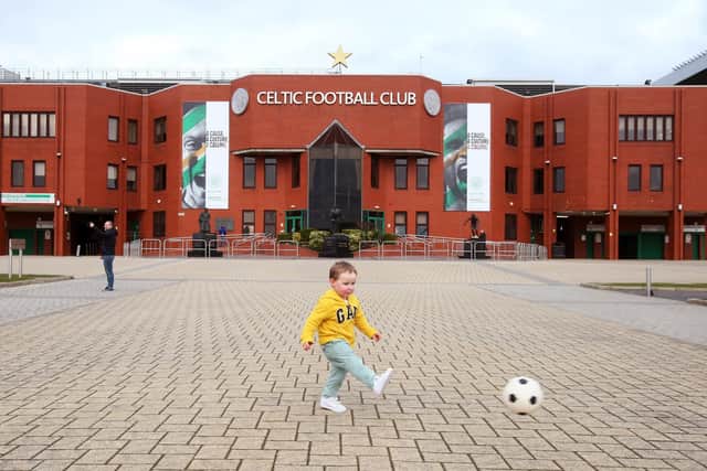 A young boy enjoys a kickabout outside Parkhead yesterday.