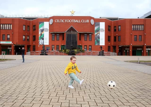 A young boy enjoys a kickabout outside Parkhead yesterday.