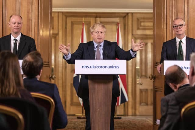 Chief Medical Officer for England Chris Whitty (left) and Chief Scientific Adviser Sir Patrick Vallance (right) stand with Prime Minister Boris Johnson during a media briefing in Downing Street. Picture: Richard Pohle/The Times/PA Wire