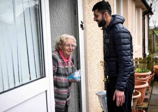 Jawad Javed delivers coronavirus protection kits that he and his wife have put together for elderly and vulnerable people in Stenhousemuir (Picture: Andy Buchanan/Digital/AFP via Getty Images)
