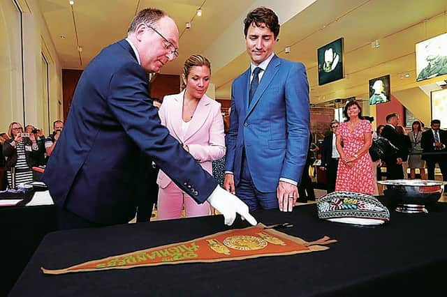 Canadian premier Justin Trudeau and NMS's David Forsyth look at some artefacts. Picture: Stewart Attwood